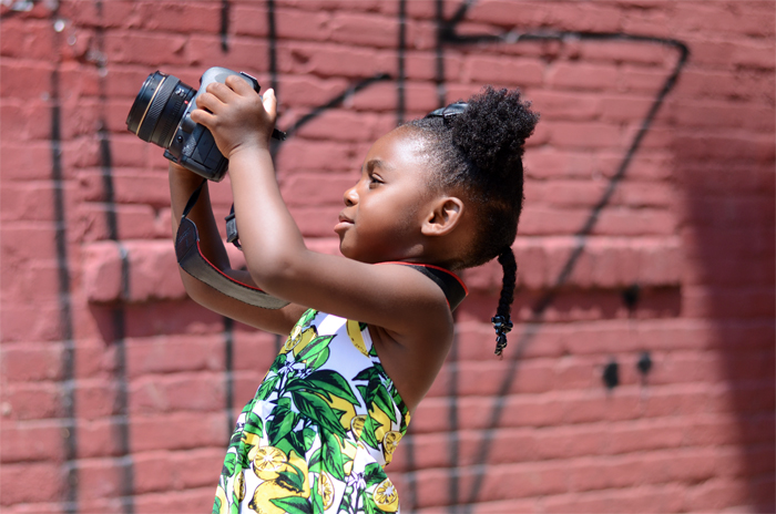 Young Girl tilting camera up.